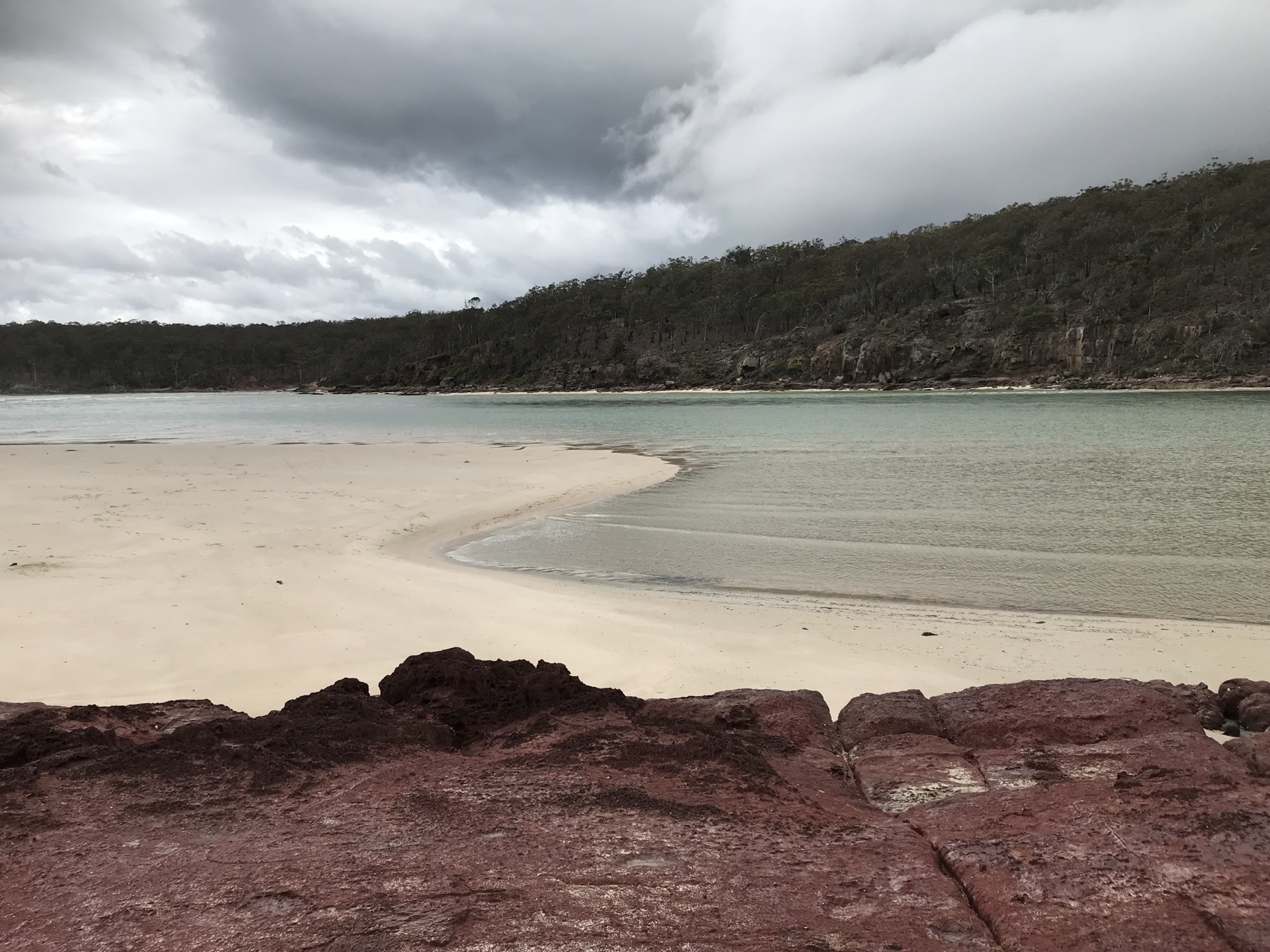 Quiet island shore under clouds